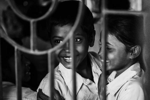 Creative art portrait of two rural Indian school children embracing — black-and-white documentary photography by byag.studio